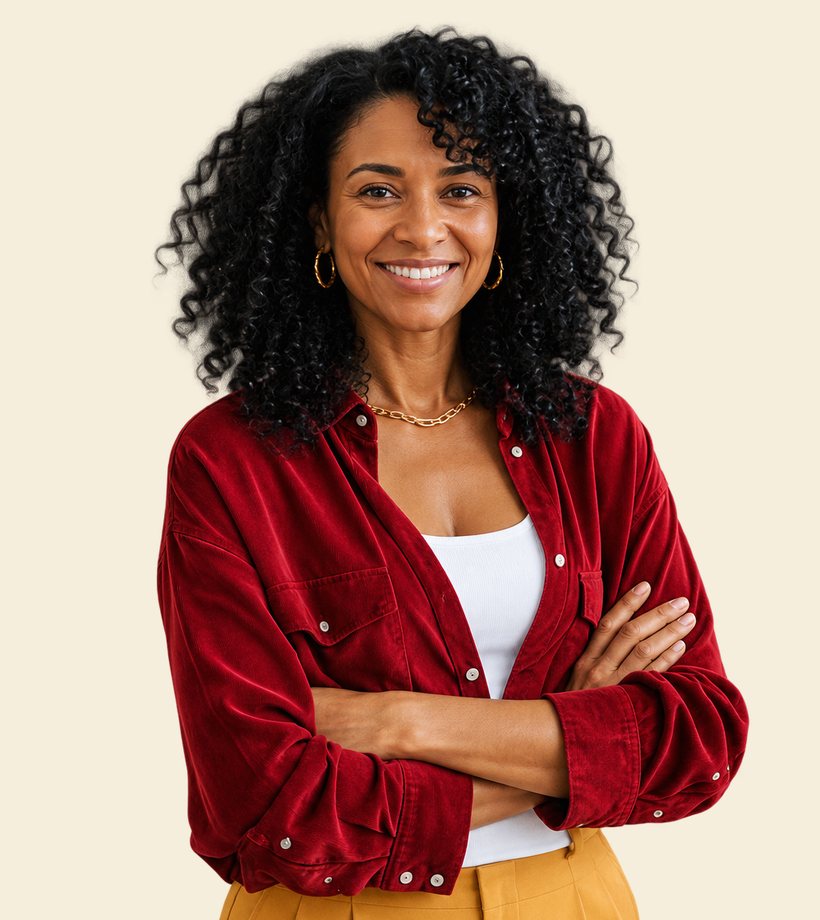 A smiling woman with curly hair, arms folded, in a red shirt